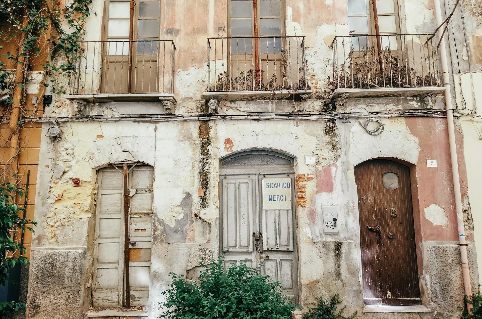 brown wooden door on white concrete building